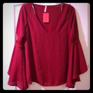 Women’s beautiful never worn wine colored blouse